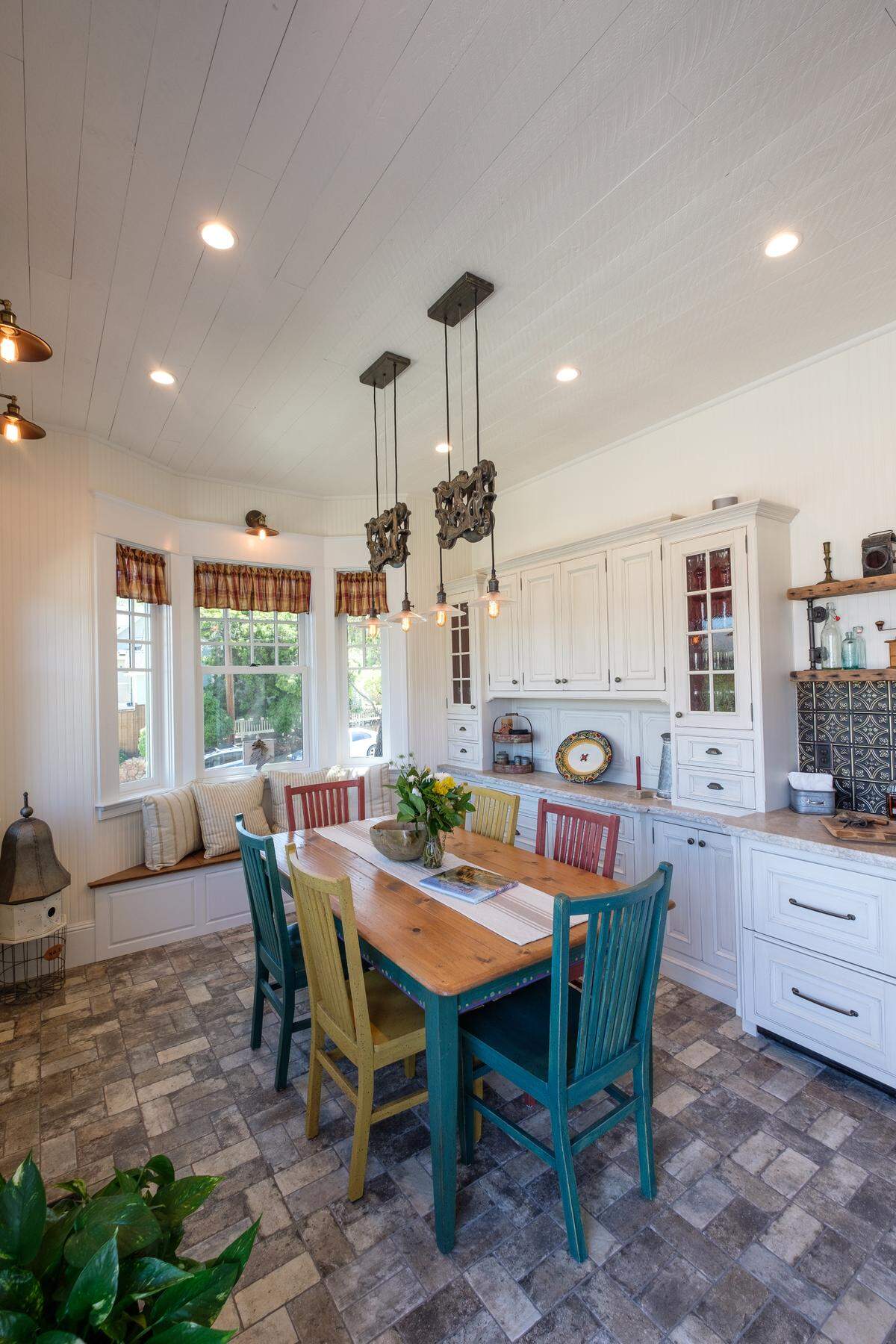 The renovated kitchen of the Stanton House in San Luis Obispo features custom handmade cabinets, leatherized quartzite countertops, rustic light fixtures and a vintage-style range.