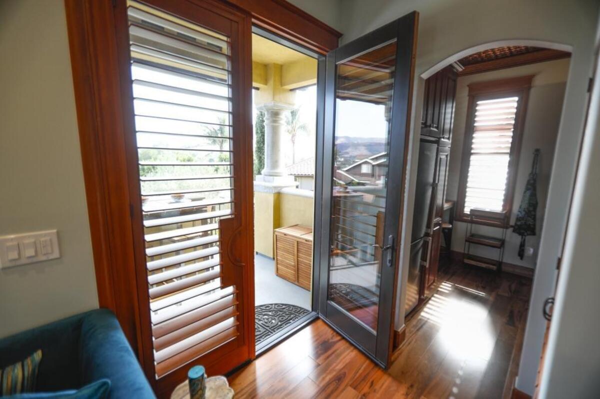 The sitting area of the Peacock’s Nest, a San Luis Obispo guest suite, opens to a patio that has a teak bar table, an outdoor cooking area and a view of Cerro San Luis.
