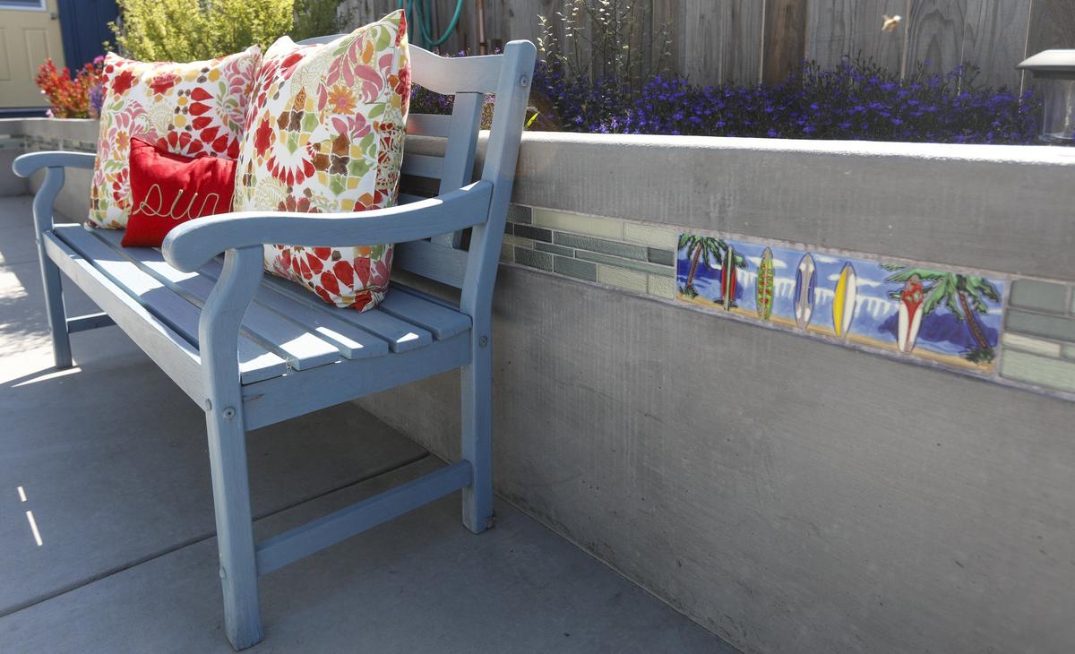 A decorative glass block in a concrete retaining wall gives Kathy and Jim Pashone’s Cayucos garden a beachy vibe.