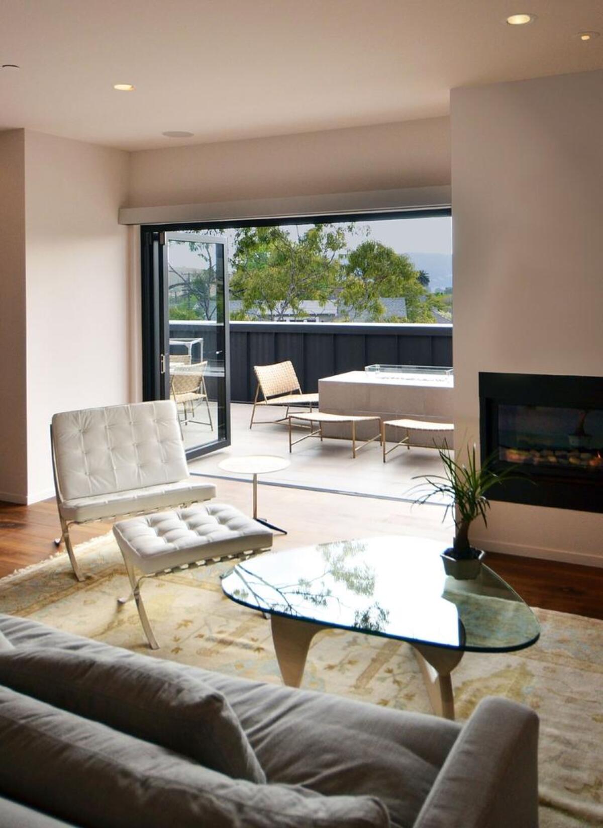 Classic modern furniture is combined with traditional elements, such as this Uzbek rug.