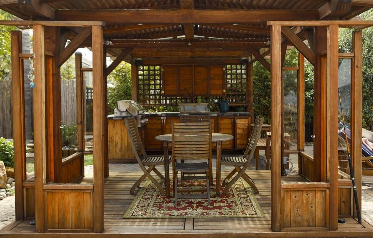 The backyard includes a covered dining area.