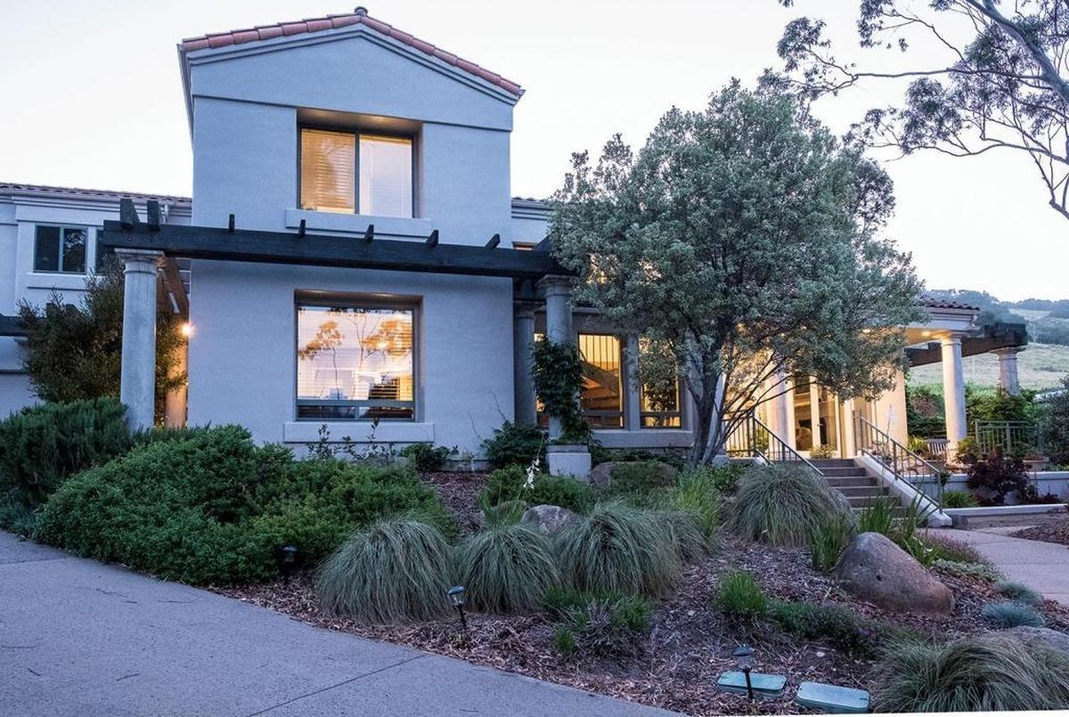 The San Luis Obispo home of Bill and Sandee Beckers features a contemporary Mediterranean style with large columns, heavy beam timbers and a steel-trowel stucco finish.