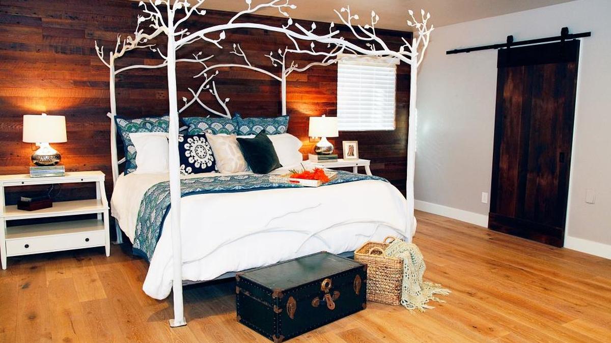 When the Minnichs bought their house, the master bedroom was completely black. The remodel transformed the room with a mostly white color palette, a wall covered in reclaimed barn wood and a rolling door.