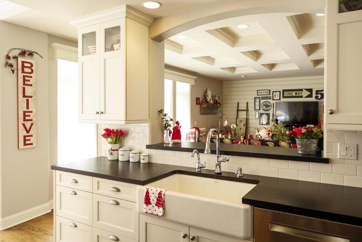 The kitchen of the Palmer home in San Luis Obispo features white, Shaker-style cabinets and matte-finish black granite countertops.