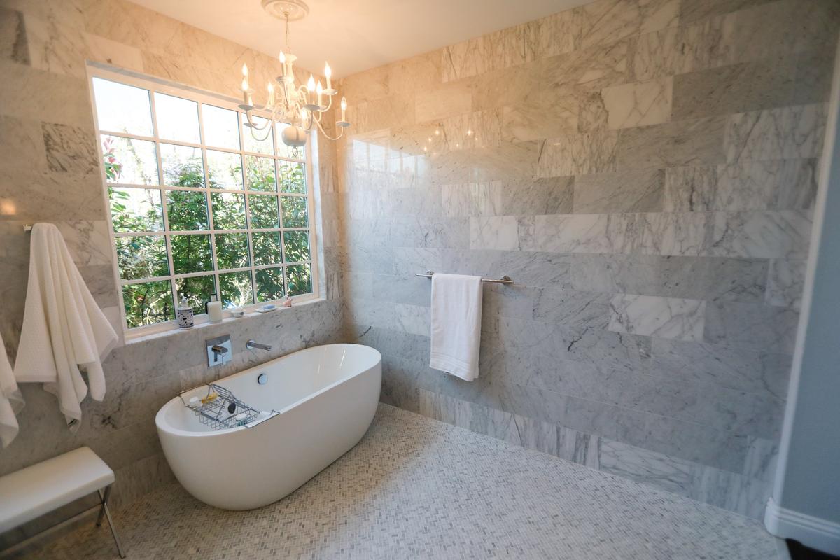 The master bathroom of Gary and Marilyn Sarina’s Arroyo Grande home features marble tiles and a new soaking tub.