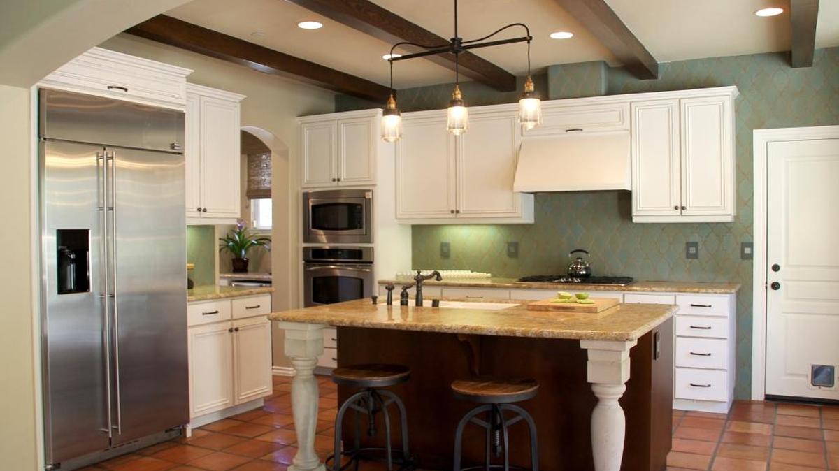 The kitchen remodel included painting cabinets white and adding concrete balusters to the island.