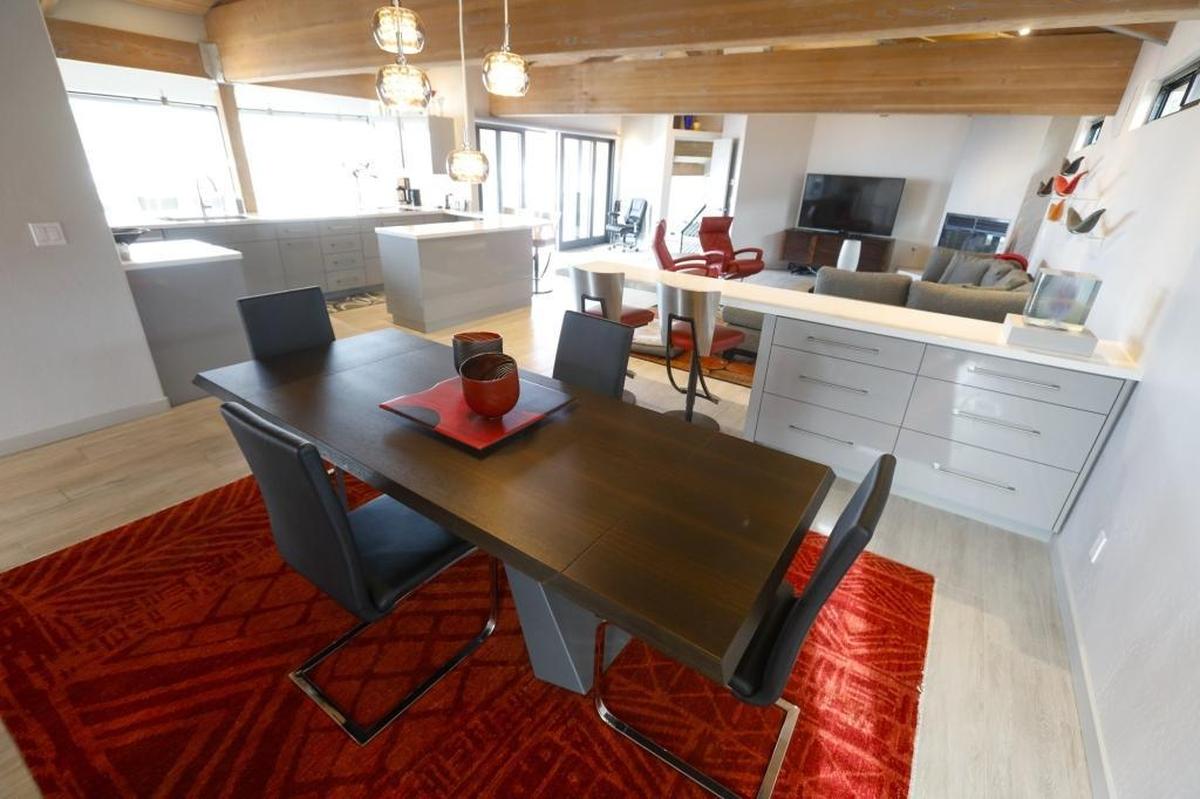 Ed and Sandy Sardella removed built-in wood bookshelves that separated the living and dining rooms in their Shell Beach home to create one open great room.