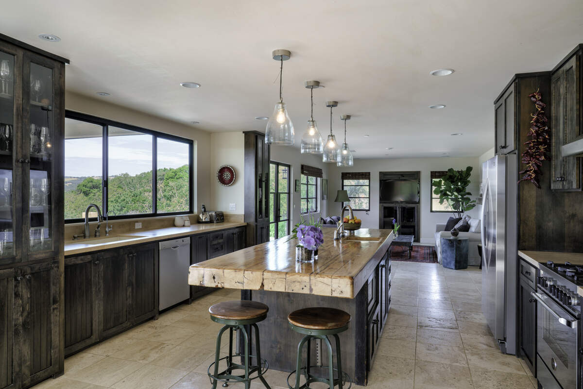 The spacious, modern kitchen of Varinder Sahi and Anita Kothari's Paso Robles home has alder cabinets and an island built from wood salvaged from a nearby barn.