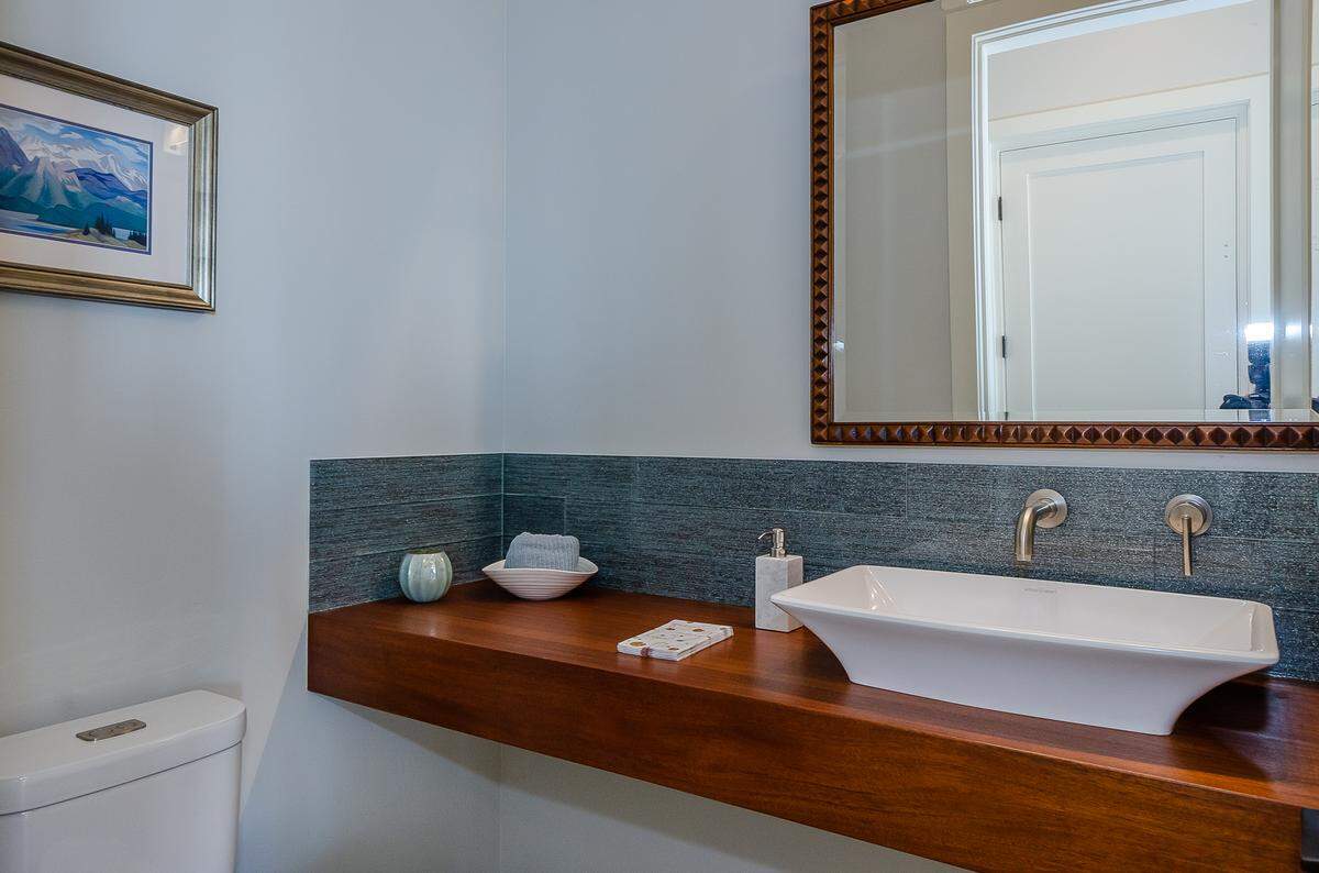 A butcher block counter built by Los Osos carpenter Mark Alfirevic matches an antique mirror in the powder room of John and Dawn Turner’s Cayucos home.
