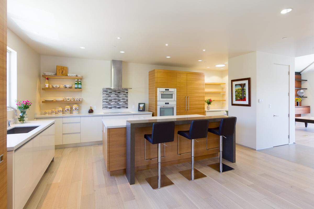 Open shelving stands in for upper cabinets in the kitchen of Karen and Lee Bren's condominium, making the space feel larger.