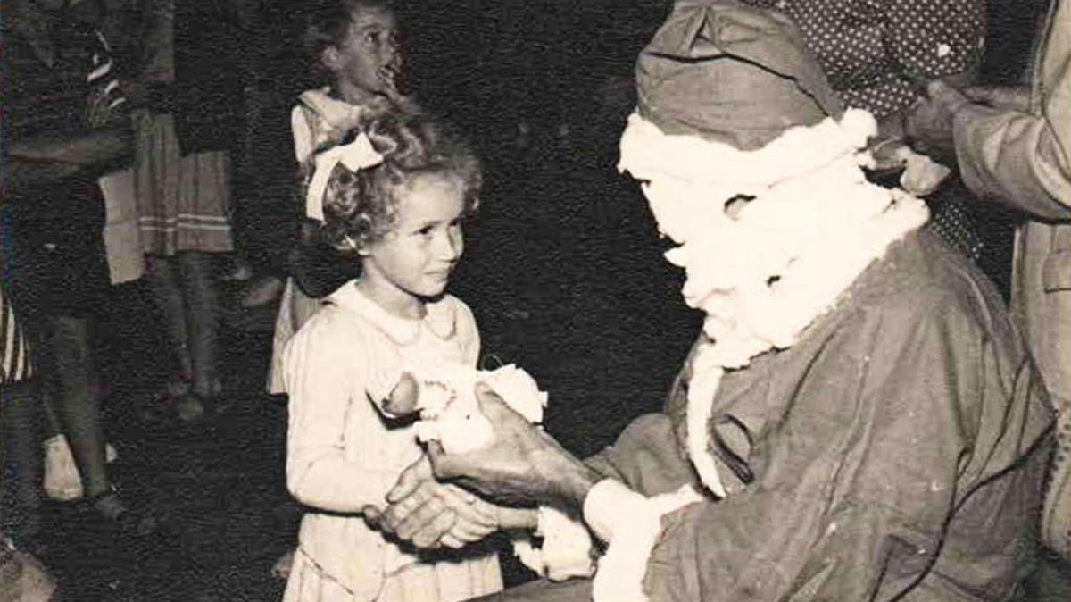 This photo is of me meeting Santa in Kerikeri, New Zealand, in 1954 at the age of 4. Though it was in the middle of summer in the Southern Hemisphere, Santa still wore his traditional North Pole outfit. He would visit our local community hall one day shortly before Christmas, and the children would line up to shake his hand and get a gift. I remember that it was a very awe-inspiring experience to actually meet such an important person. Pam Loan, San Luis Obispo