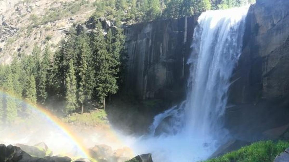 A rainbow shines in the spray of Vernal Fall on the Mist Trail, one of the most popular hikes in Yosemite National Park.