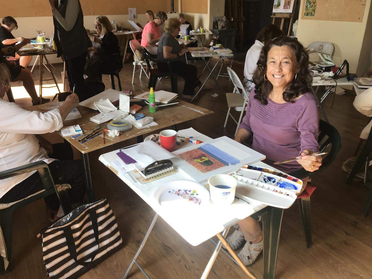 Student Lisa Rothrock poses for a picture with her art at a workshop taught by Tricia Reichert at the Verrochio Art Centre in Casole d’Elsa, Italy.