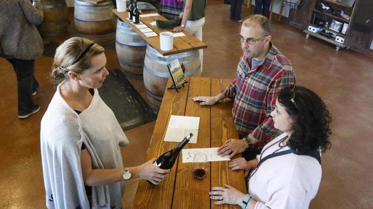 Darren and Shawn Selsky from Austin, Texas, have vacationed in Napa/Sonoma for the last 10 years, but when wildfires broke out in the area, their hosts recommended Paso Robes as an alternative. Serving is Melissa Swanson, director of hospitality at Alta Colina. The winery is among those in the Paso Robles area that have seen an upswing in visits as Napa/Sonoma tourism diverts in the wake of devastating fires.