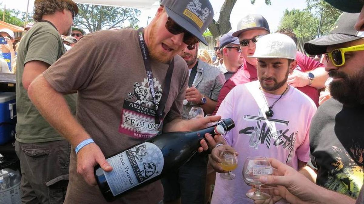 Jim Crooks, who brews for Firestone Walker Brewing Co’s Barrelworks, pours Feral Vinifera into the glasses of waiting fans, at the Firestone Walker Invitational Beer Fest on Saturday, May 30, 2015, at the Paso Robles Event Center.