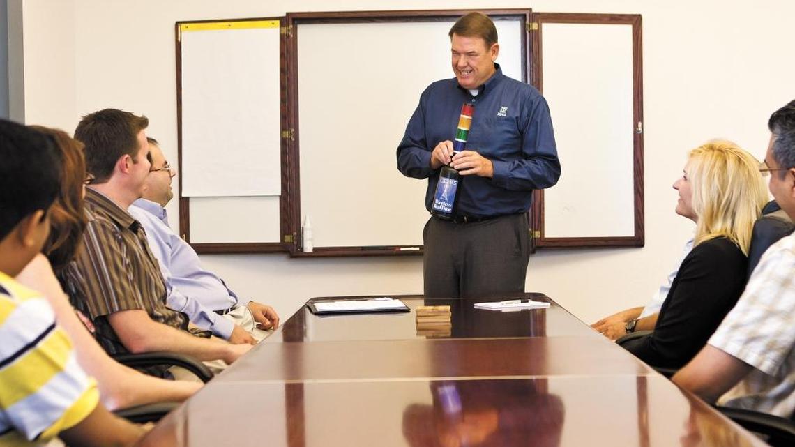 Randy Flamm, talking to employees at IQMS in Paso Robles in 2011, has stepped down as CEO but continues to play a significant role at the company.