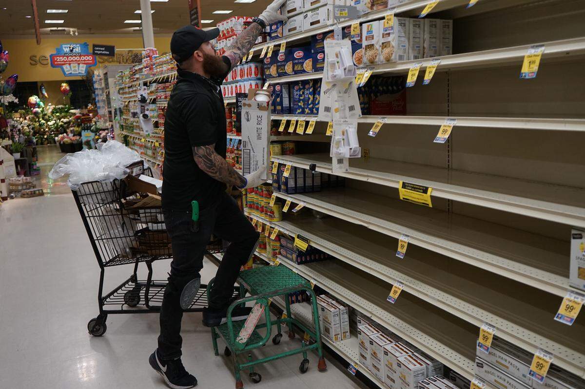 Tap Truck Central Coast owner Joshua James stocks shelves in his new job at Vons supermarket in San Luis Obispo.
