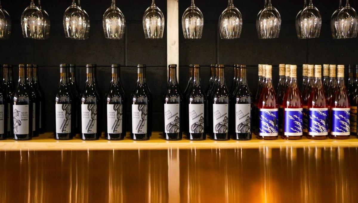 Bottles of wine lines the shelves at Sans Liege winery’s new tasting room in Paso Robles’ Tin City.