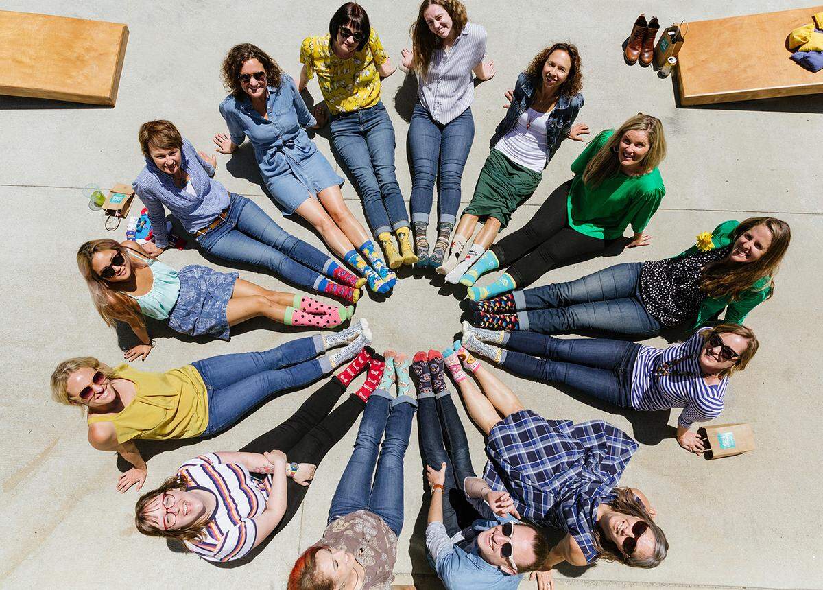 Employees of The Sock Drawer pose for a photo. The business closed its shop but will continue online sales. 