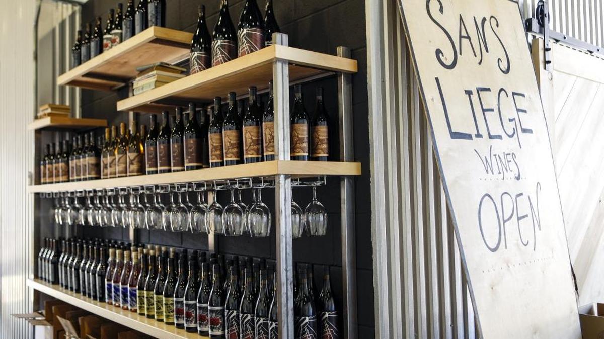 Bottles of wine lines the shelves at Sans Liege winery’s new tasting room in Paso Robles’ Tin City.