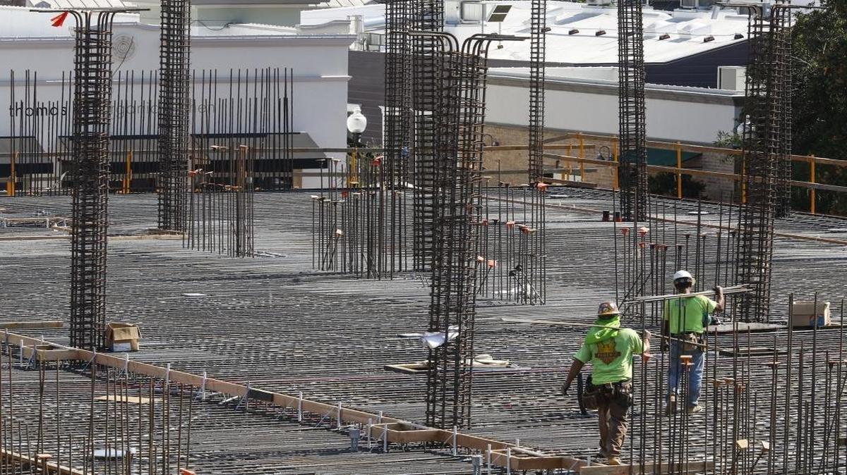 Ironworkers walk concrete reinforcing bar to the Chinatown project between Monterey and Palm Streets in San Luis Obispo.