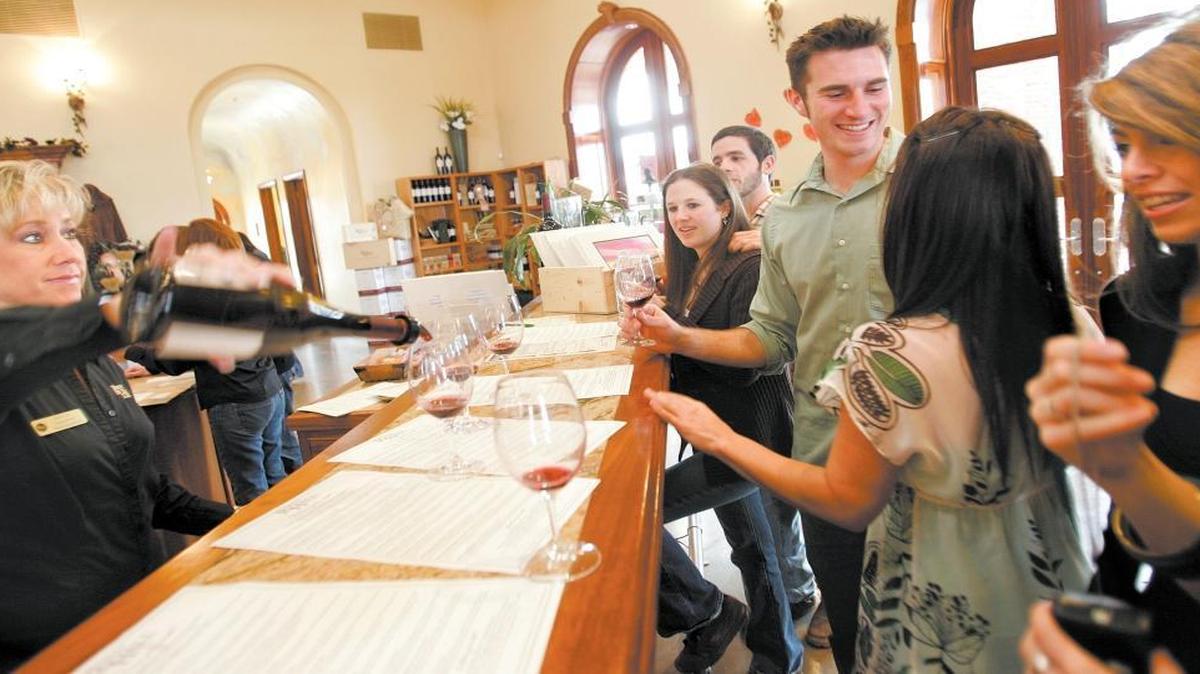 Milisa Lass, left, pours wine for customers at the Robert Hall Winery tasting room in a 2007 photo.