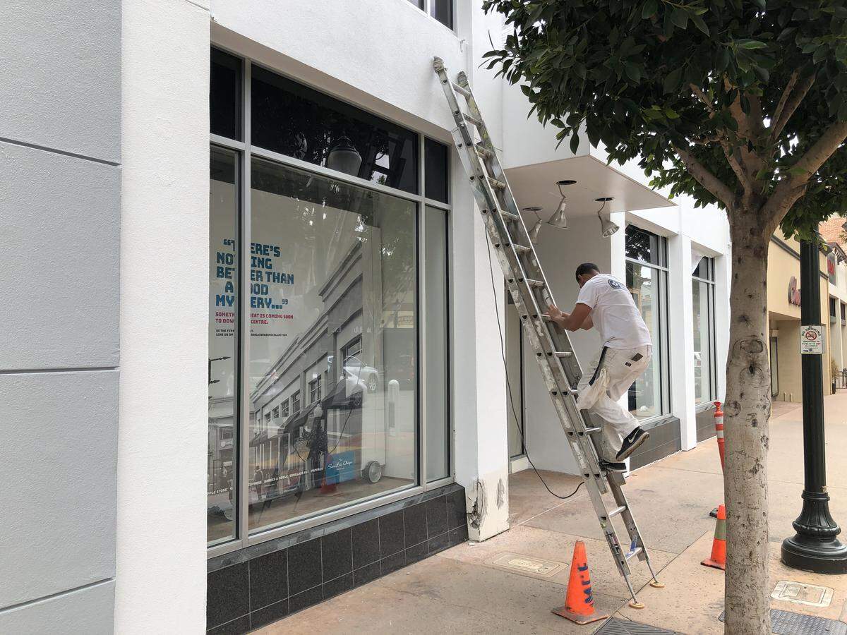 A painter spruces up the commercial space that once housed The Gap clothing store in downtown San Luis Obispo. Athleta, which sells women's workout wear, will move into the former Gap location.