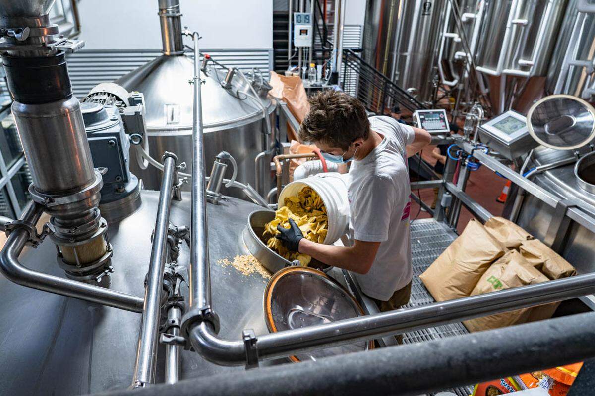 SLO Brew brewers add tortilla chips from Taco Works as part of the brewing process to make the limited-edition Tortilla Chip Lager.