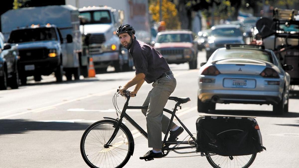 Dan Rivoire crosses Monterey St. in San Luis Obispo. Five San Luis Obispo County employers have received a national designation of best workplaces for commuters based on benefits that include subsidizing bus fares, carpooling programs and access to an Emergency Ride Home program, which offers workers who would normally bike, carpool or use public transit access to a free or low-cost ride home in cases of emergency.