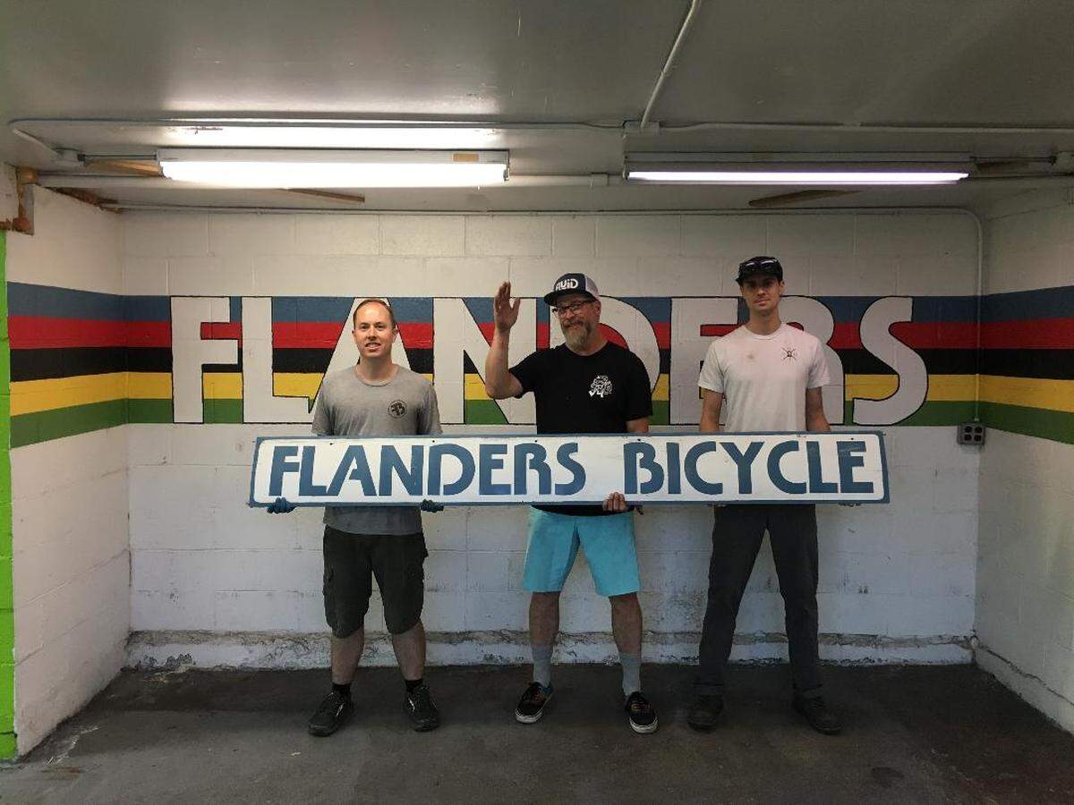 Shawn Hafley, owner of Flanders Bicycle in San Luis Obispo, poses for a picture with employees Sandy Bohn, left, and Adam Jacinto, right.