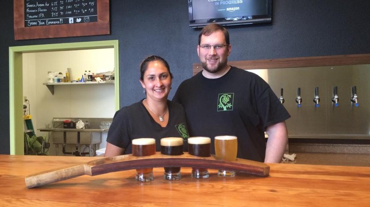 Kristen and Jason Tesarz behind the bar at Little Tree Brewing in Grover Beach.