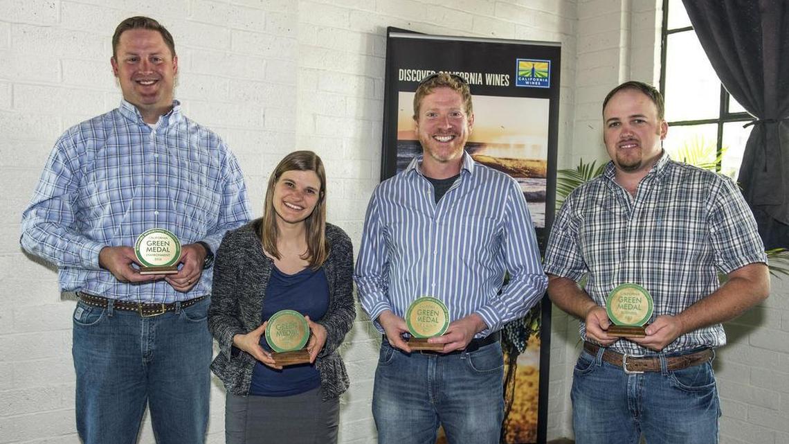 Lucas Pope of Halter Ranch Vineyard, Katie Jackson of Jackson Family Wines, Jason Haas of Tablas Creek Vineyard, and Dirk Heuvel of McManis Family Vineyards hold their California Green Medal awards.
