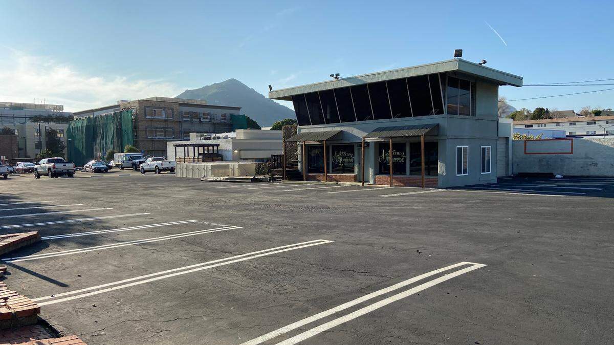 A proposal in 2022 called for turning an old used car lot at Higuera and Toro streets in San Luis Obispo into a food court built from repurposed shipping containers. Now, the city is buying the property from NKT Commercial to use as a parking lot.