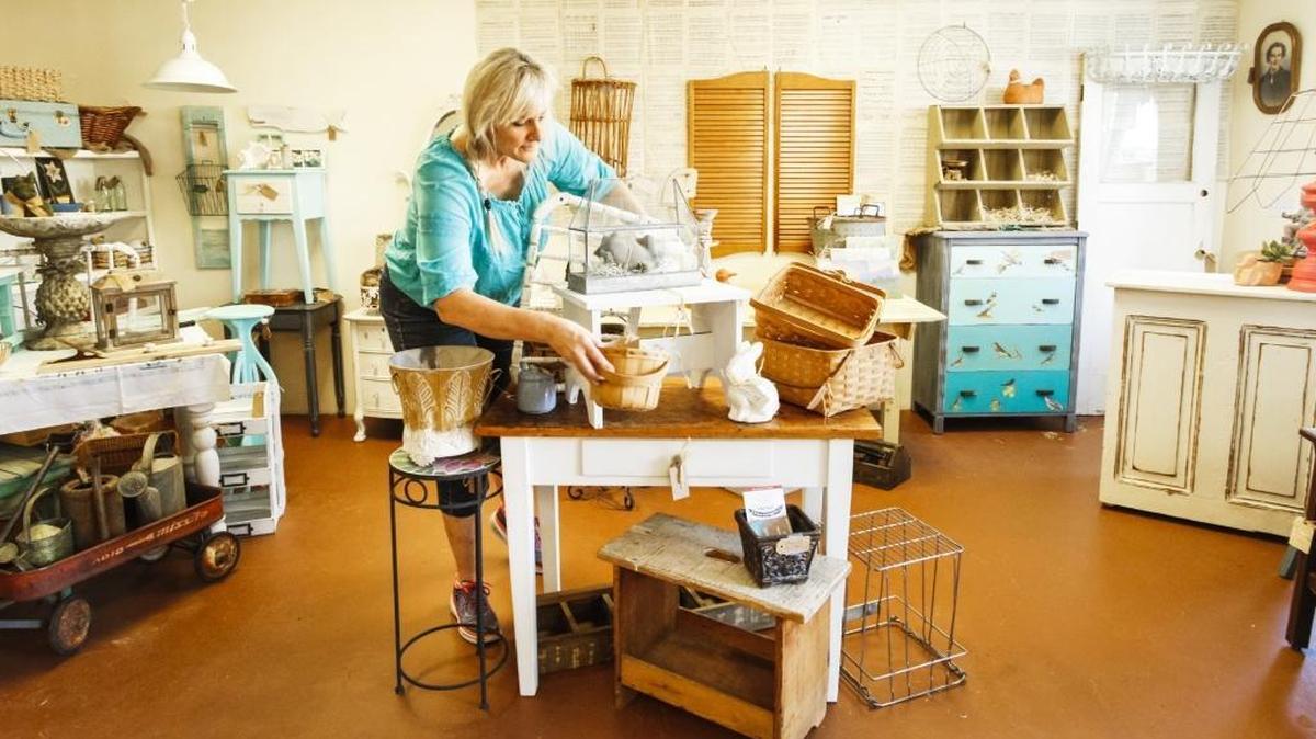 Jennifer Little sets up her booth at the Junque Love pop-up vintage market in Grover Beach. The market will be open for business on Friday and Saturday.