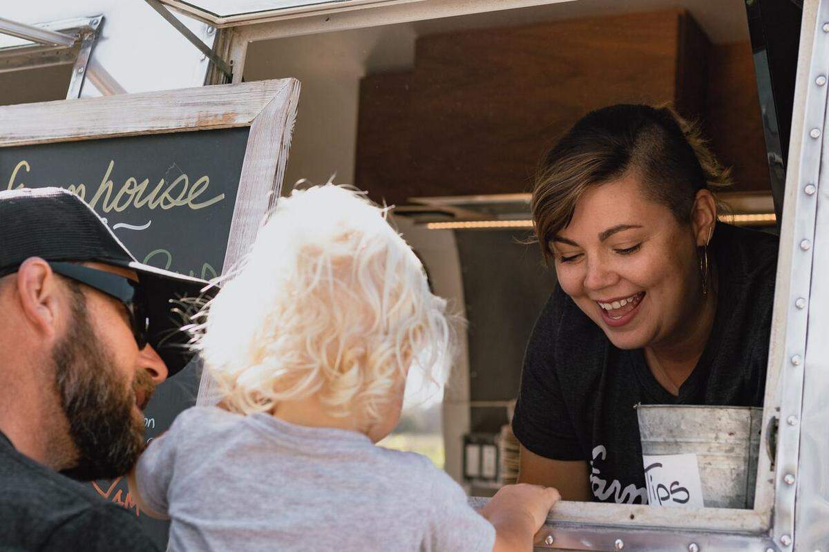 The Farmhouse Airstream trailer serves a young customer.