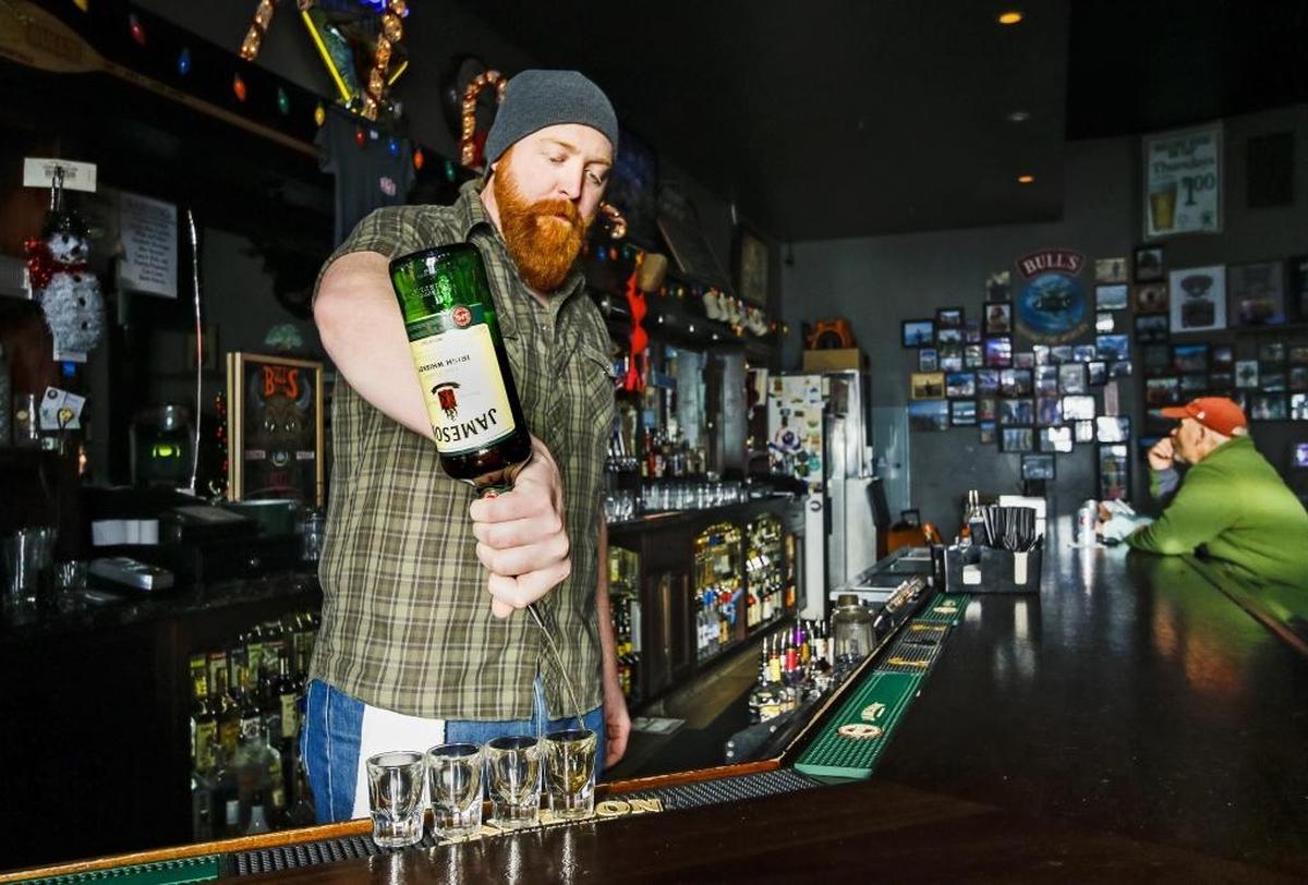 Bartender Patrick Drom pours some shots at Bull’s Tavern in San Luis Obispo in 2016. 