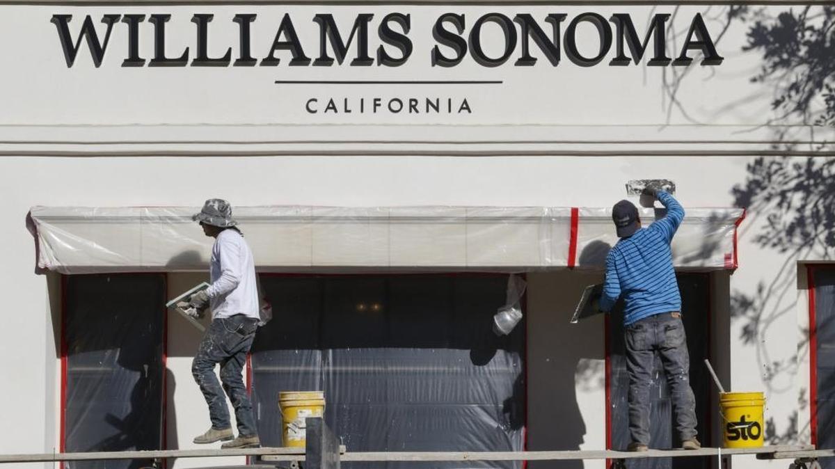 Pablo Mendoza, left, and Montserrat Camarena finish the plaster on the Williams-Sonoma building in downtown San Luis Obispo. The store is slated to open later this week on Monterey Street as part of the Chinatown project.