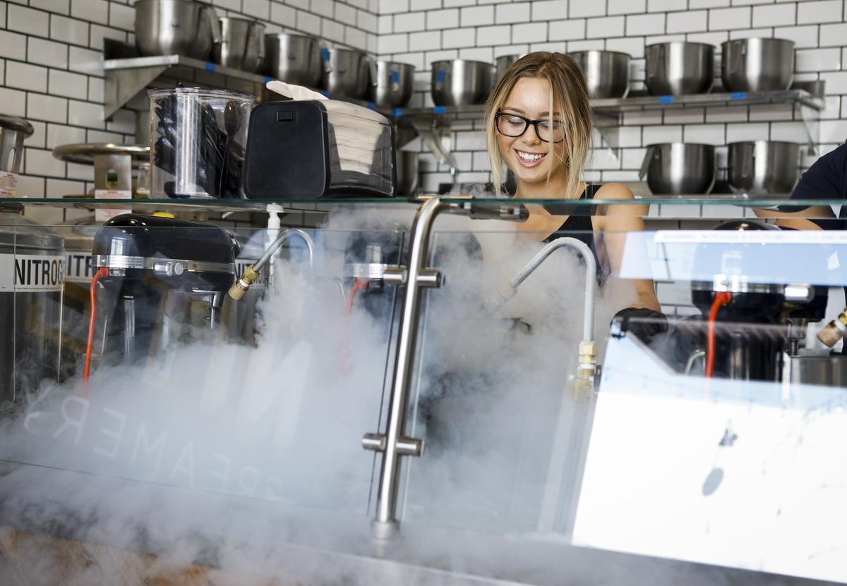 Charisma Baxter injects liquid nitrogen into a milk base as she makes an ice cream creation at the Nite Creamery ice cream shop in San Luis Obispo.