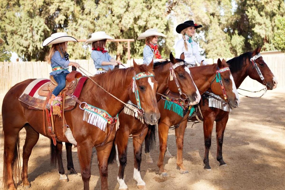 Rodeo Quincy founder Quincy Freeman, far right, designs ornate horse tack as well as western wear.