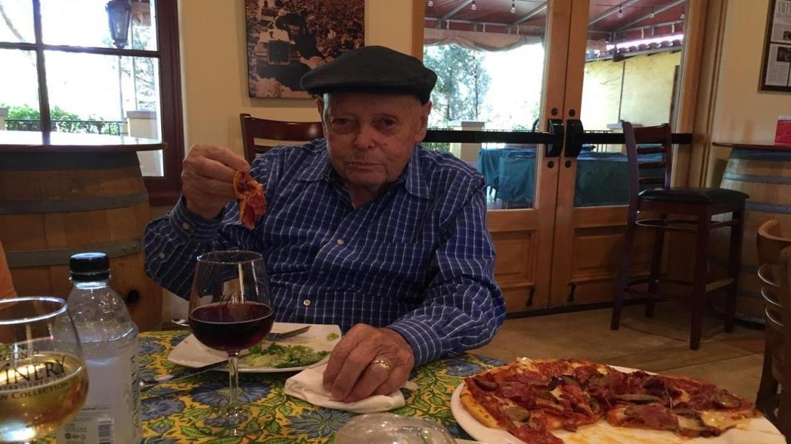 Family patriarch Stefano Riboli samples a pizza from the bistro at San Antonio’s Paso tasting room.