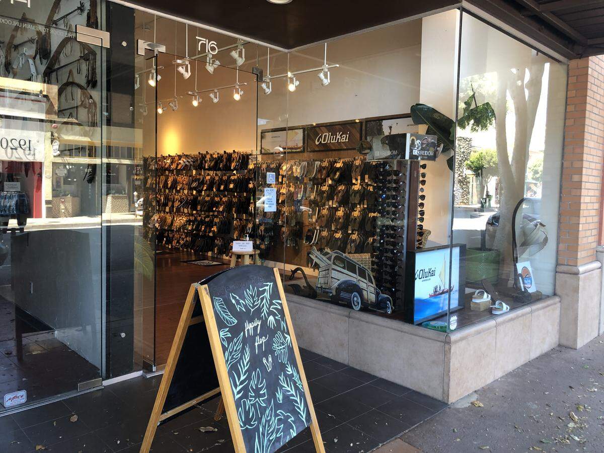 The Flip Flop Shop is allowing one customer at a time, according to its sign.