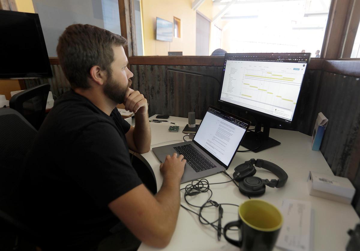 Three former Cal Poly students founded the company Flume that offers a water-tracking device and app, called the Flume Smart Water System, to allow users to monitor their water usage. Co-founder James Fazio working at his desk.