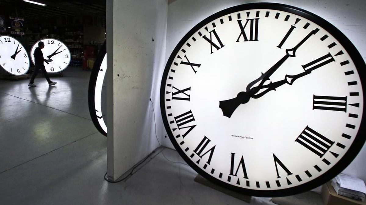 Tom Liberatore, a materials purchasing manager, walks past clocks being tested prior to shipping at the Electric Time Company in Medfield, Mass., on March 10. The state Senate on Tuesday rejected Assembly Bill 385, which would have placed a measure on the ballot asking voters to dump the twice-annual changing of the clocks and keep California on standard time year-round.