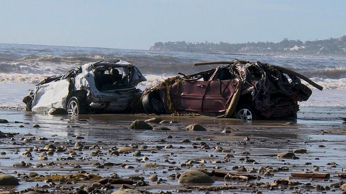 In this Wednesday, Jan. 10, 2018 still image from video, cars and debris that washed to the coast from storms and flooding are shown on a beach in Montecito, Calif. Santa Barbara County area beaches are closed due to high levels of bacteria found in ocean water after the storm carried unknown amounts of untreated sewage and waste out to the ocean.