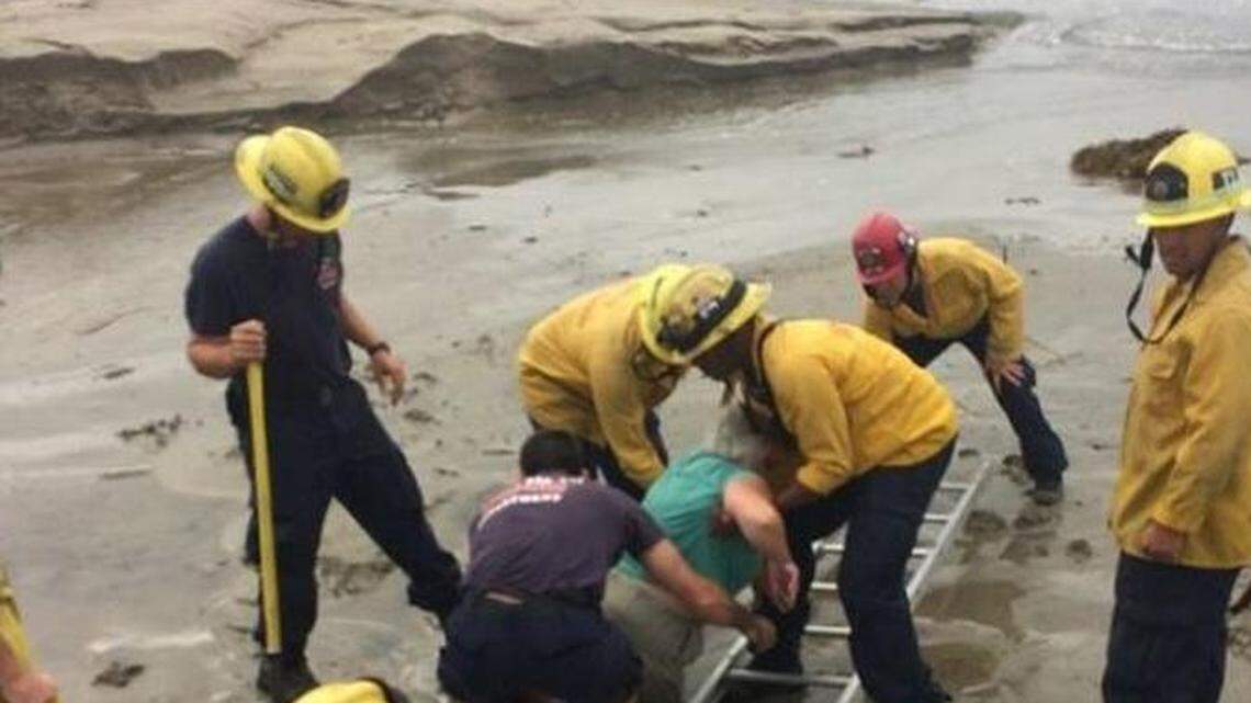 A woman became trapped in waist-deep sand at the mouth of Mission Creek in Santa Barbara and was rescued Tuesday morning. Her rescuers also got stuck in the sand, officials said.