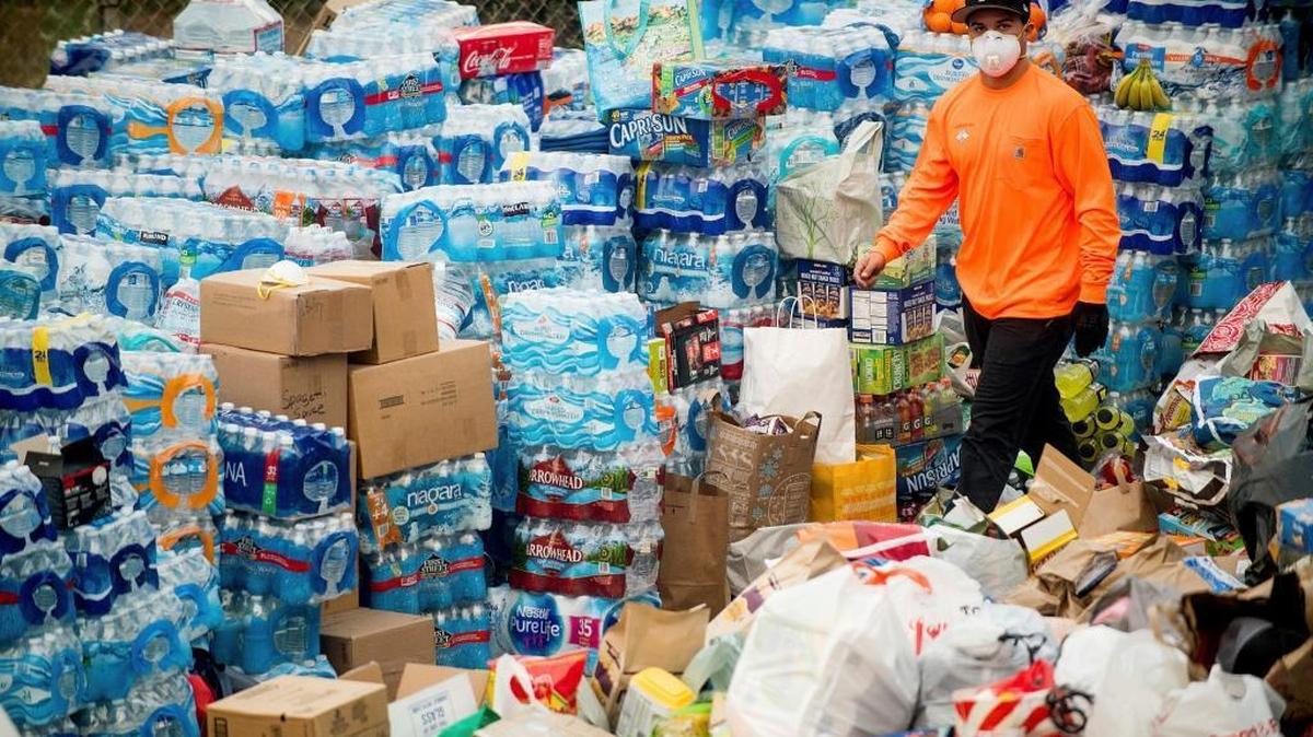 A volunteer passes supplies donated to Thomas Fire evacuees in Ventura, Calif., on Wednesday, Dec. 6, 2017. As many as five fires have closed highways, schools and museums, shut down production of TV series and cast a hazardous haze over the region. About 200,000 people were under evacuation orders. No deaths and only a few injuries were reported.