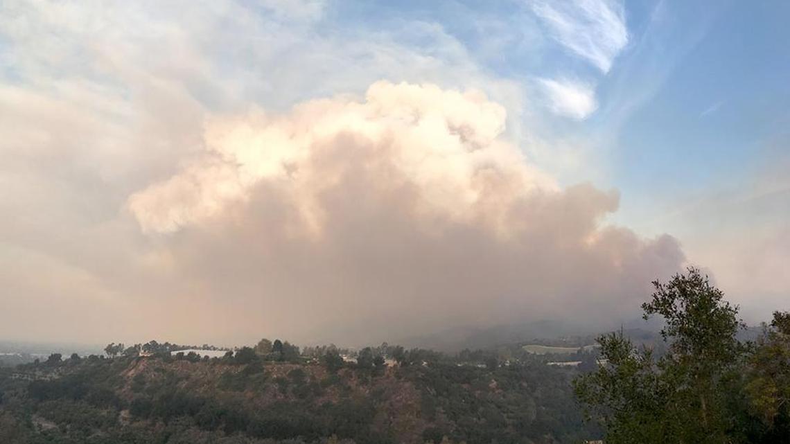 A large cloud of smoke rises from the Thomas Fire Sunday morning, as seen from Cate School. The blaze was threatening neighborhoods in Carpinteria and prompting widespread evacuations.