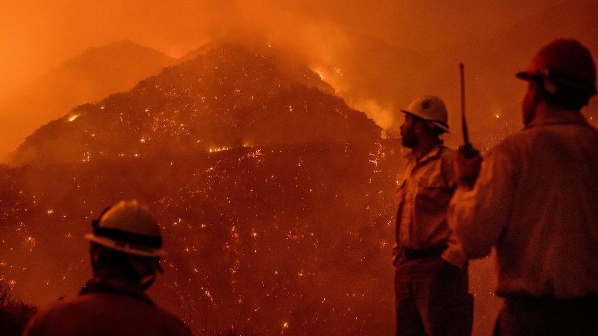 In this Dec. 8, 2017, file photo, firefighters monitor the Thomas fire as it burns through Los Padres National Forest near Ojai, Calif. State fire officials said Friday, Dec. 22, 2017, that the Thomas fire has scorched 273,400 acres, or about 427 square miles of coastal foothills and national forest.