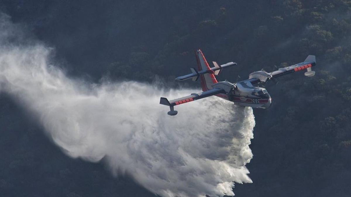A Bombardier 415 Superscooper makes a water drop Sunday, December 17, 2017, on hot spots along the hillside east of Gibraltar Road as the Thomas Fire burns into its 14th day. Calmer conditions are allowing firefighters to go on attack against the stubborn blaze.