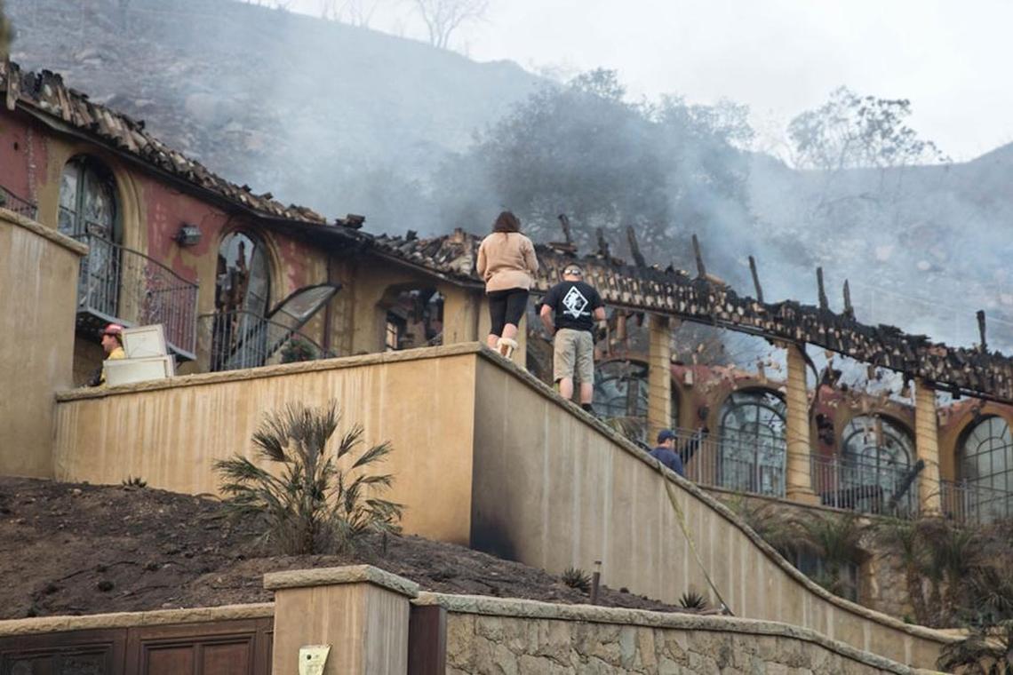 Residents survey their burned-out home on Park Hill Lane in Montecito on Sunday, a day after the Thomas Fire roared through the area.